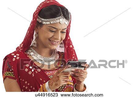 Female dandiya dancer reading an sms View Large Photo Image Stock Image - Female dandiya dancer reading an sms . Fotosearch