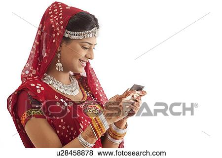 Female dandiya dancer reading an sms View Large Photo Image Stock Photo - Female dandiya dancer reading an sms . Fotosearch
