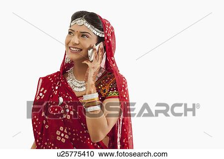 Female dandiya dancer talking on a mobile phone View Large Photo Image Stock Image - Female dandiya dancer talking on a mobile phone . Fotosearch