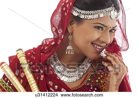 Picture - Female dandiya dancer with sticks . Fotosearch