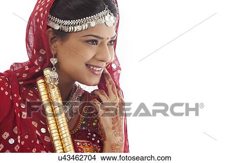Picture - Female dandiya dancer with sticks . Fotosearch