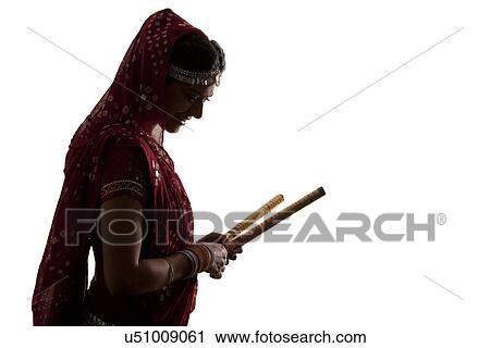Female dandiya dancer with sticks View Large Photo Image Stock Image - Female dandiya dancer with sticks . Fotosearch