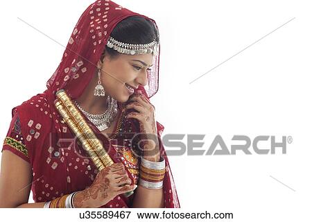 Stock Photo - Female dandiya dancer with sticks . Fotosearch
