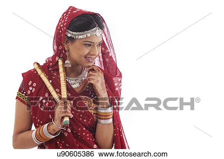 Stock Photograph - Female dandiya dancer with sticks . Fotosearch