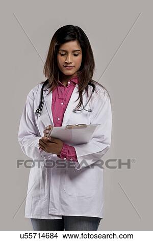 Picture - Female doctor with a clip board . Fotosearch