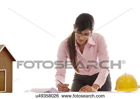 Stock Photograph - Female engineer making blueprints . Fotosearch