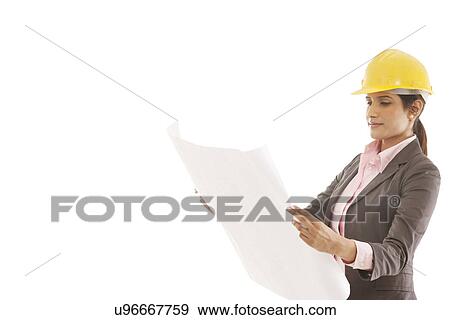 Stock Photo - Female engineer reading blueprints . Fotosearch