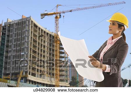 Female engineer with blueprints View Large Photo Image Stock Photo - Female engineer with blueprints . Fotosearch