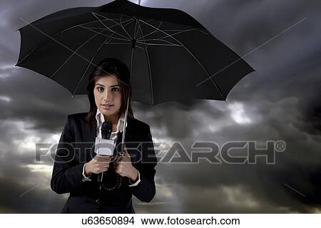 Female reporter standing in rain View Large Photo Image Picture - Female reporter standing in rain . Fotosearch