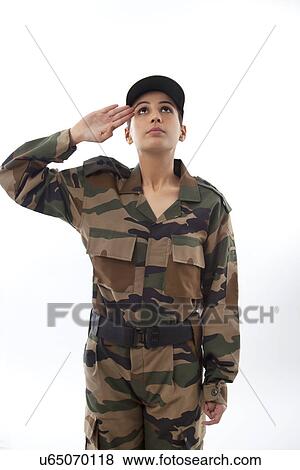 Stock Photo - Female soldier saluting looking up against white background . Fotosearch