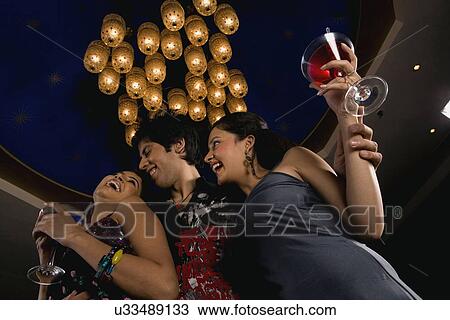 Friends enjoying their drink View Large Photo Image Stock Image - Friends enjoying their drink . Fotosearch
