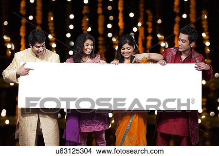 Picture - Friends holding a white board. Fotosearch