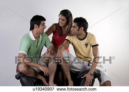 Stock Photo - Friends sitting on a sofa . Fotosearch