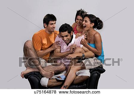 Friends sitting on a sofa View Large Photo Image Stock Photo - Friends sitting on a sofa . Fotosearch