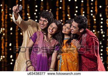 Friends with camera taking a self portrait View Large Photo Image Stock Photo - Friends with camera taking a self portrait. Fotosearch