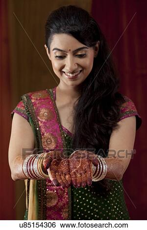 Front view of smiling young bride showing her henna tattoo View Large Photo Image Stock Photograph - Front view of smiling young bride showing her henna tattoo . Fotosearch