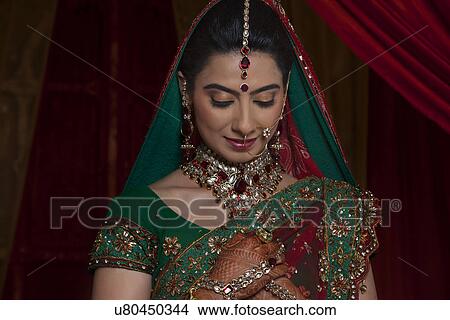 Front view of young Indian bride looking down View Large Photo Image Picture - Front view of young Indian bride looking down . Fotosearch