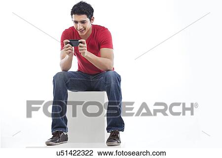 Full length of a man using phone for text messaging against white background View Large Photo Image Stock Image - Full length of a man using phone for text messaging against white background . Fotosearch