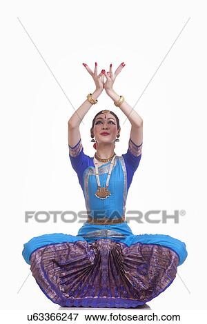 Stock Photo - Full length of beautiful Bharat Natyam dancer performing over white background. Fotosearch