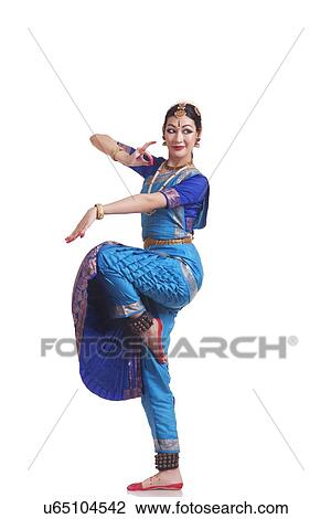 Stock Image - Full length of beautiful Bharatanatyam dancer performing on white background. Fotosearch