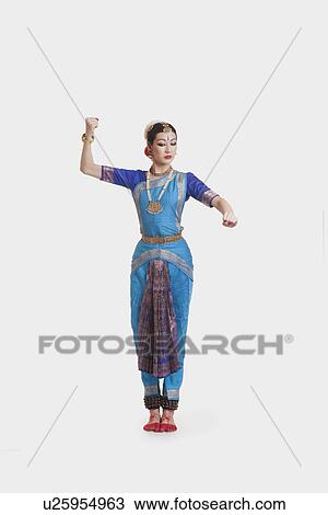 Full length of beautiful dancer performing Bharatanatyam against white background View Large Photo Image Stock Image - Full length of beautiful dancer performing Bharatanatyam against white background. Fotosearch