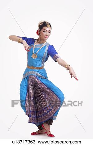 Full length of beautiful woman performing Indian Bharat Natyam dance on white background View Large Photo Image Stock Image - Full length of beautiful woman performing Indian Bharat Natyam dance on white background. Fotosearch