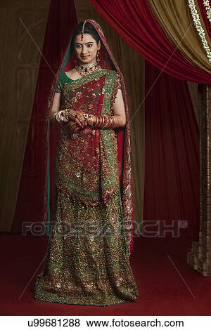 Full length of beautiful young bride standing View Large Photo Image Stock Photo - Full length of beautiful young bride standing . Fotosearch