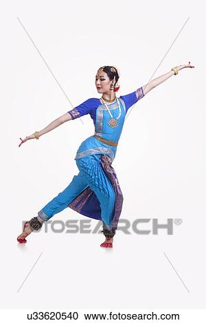 Full length of Bharat Natyam dancer performing over white background View Large Photo Image Stock Image - Full length of Bharat Natyam dancer performing over white background. Fotosearch