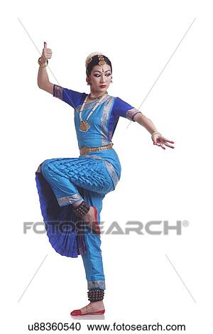 Stock Image - Full length of Bharatanatyam classical dancer performing over white background. Fotosearch