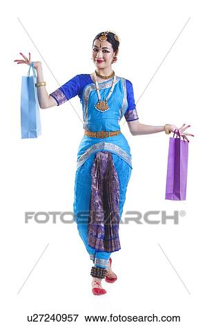 Full length of Bharatanatyam dancer with shopping bags posing over white background View Large Photo Image Stock Photo - Full length of Bharatanatyam dancer with shopping bags posing over white background. Fotosearch
