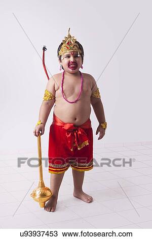 Full length of boy dressed as God Hanuman standing against wall View Large Photo Image Stock Image - Full length of boy dressed as God Hanuman standing against wall. Fotosearch