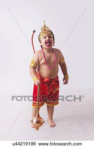 Full length of boy dressed as God Hanuman screaming at home View Large Photo Image Stock Photo - Full length of boy dressed as God Hanuman screaming at home. Fotosearch