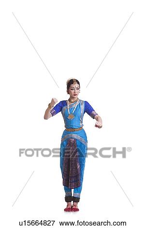 Stock Photo - Full length of dancer gesturing while performing Bharatanatyam against white background. Fotosearch