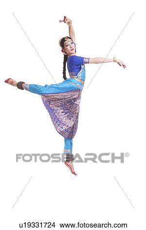 Picture - Full length of dancer in traditional wear performing Bharatanatyam against white background. Fotosearch