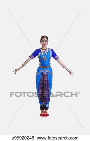 Full length of dancer in traditional wear performing Bharatanatyam against white background View Large Photo Image Stock Photo - Full length of dancer in traditional wear performing Bharatanatyam against white background. Fotosearch