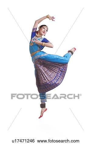 Stock Photograph - Full length of dancer performing Bharatanatyam against white background. Fotosearch