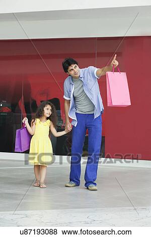 Full length of father and daughter pointing at something View Large Photo Image Stock Photo - Full length of father and daughter pointing at something . Fotosearch