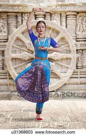Full length of female Bharat Natyam dancer performing against carved wall View Large Photo Image Stock Image - Full length of female Bharat Natyam dancer performing against carved wall. Fotosearch