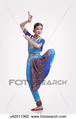 Full length of female Bharat Natyam dancer performing over white background View Large Photo Image Stock Image - Full length of female Bharat Natyam dancer performing over white background. Fotosearch