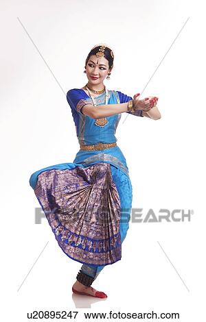 Full length of happy young woman performing Bharatanatyam over white background View Large Photo Image Stock Photo - Full length of happy young woman performing Bharatanatyam over white background. Fotosearch