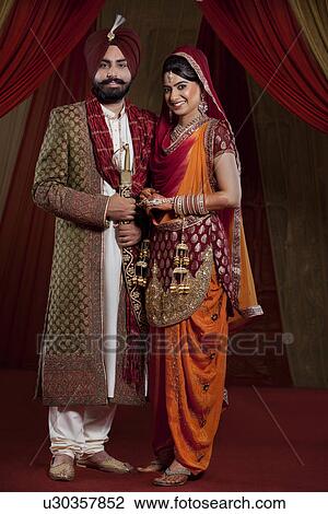 Full length of mid adult couple smiling View Large Photo Image Stock Image - Full length of mid adult couple smiling . Fotosearch