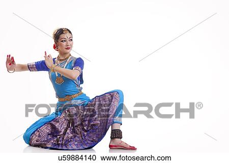 Full length of woman performing Bharatanatyam against white background View Large Photo Image Stock Image - Full length of woman performing Bharatanatyam against white background. Fotosearch