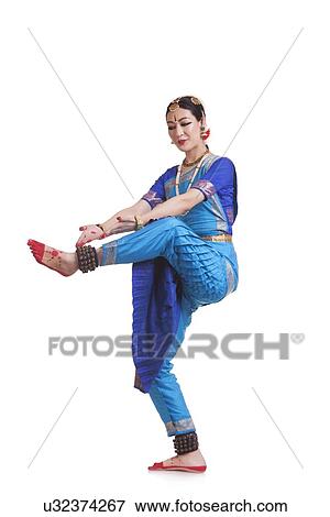 Full length of woman performing Bharatanatyam against white background View Large Photo Image Stock Photo - Full length of woman performing Bharatanatyam against white background. Fotosearch