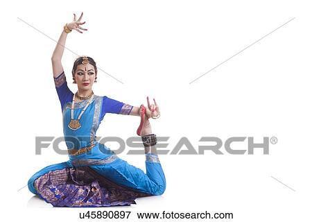 Stock Photo - Full length of woman performing Bharatanatyam against white background. Fotosearch