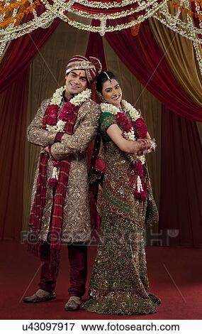 Stock Photo - Full length of young couple standing . Fotosearch