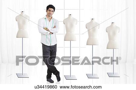 Full length of young male fashion designer standing by mannequin at studio View Large Photo Image Stock Image - Full length of young male fashion designer standing by mannequin at studio . Fotosearch