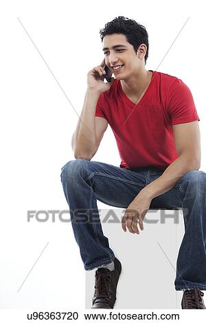 Full length of young man on the phone over white background View Large Photo Image Stock Image - Full length of young man on the phone over white background . Fotosearch
