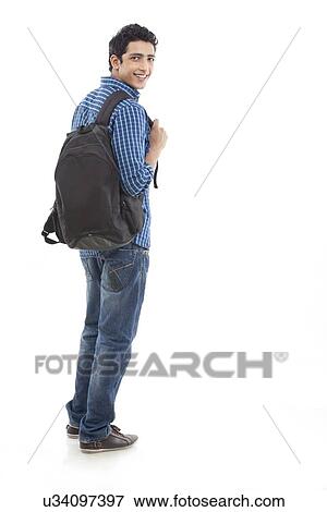 Stock Photo - Full length of young man walking with bag against white background . Fotosearch