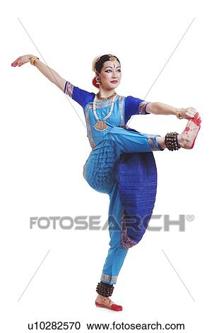Full length of young woman performing Bharatanatyam over white background View Large Photo Image Stock Image - Full length of young woman performing Bharatanatyam over white background. Fotosearch