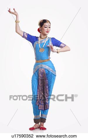 Full length of young woman performing Bharatanatyam over white background View Large Photo Image Stock Image - Full length of young woman performing Bharatanatyam over white background. Fotosearch